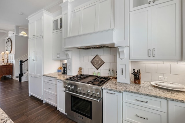 kitchen featuring dark wood-style flooring, custom exhaust hood, glass insert cabinets, white cabinetry, and high end stove