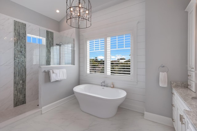 full bath with baseboards, marble finish floor, vanity, a freestanding tub, and a walk in shower