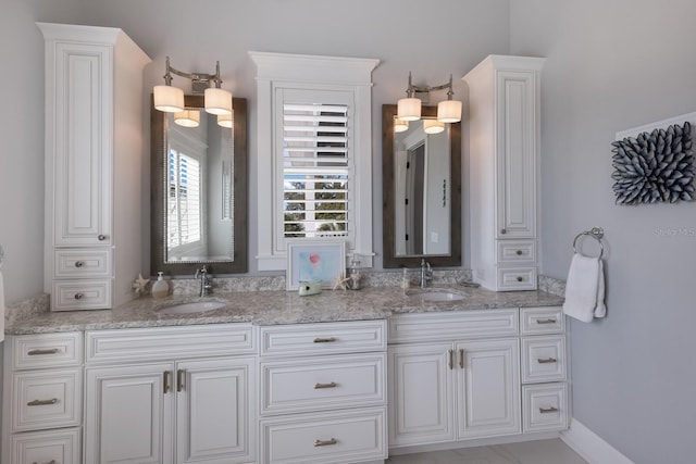 bathroom featuring a sink and double vanity