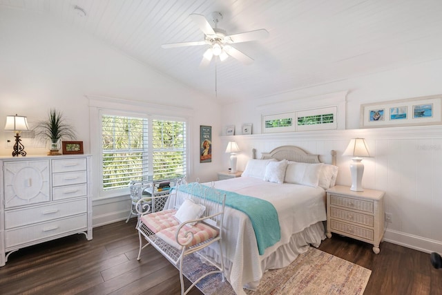 bedroom featuring dark wood-style floors, baseboards, and vaulted ceiling