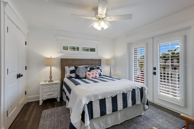 bedroom featuring a ceiling fan, access to outside, baseboards, and wood finished floors