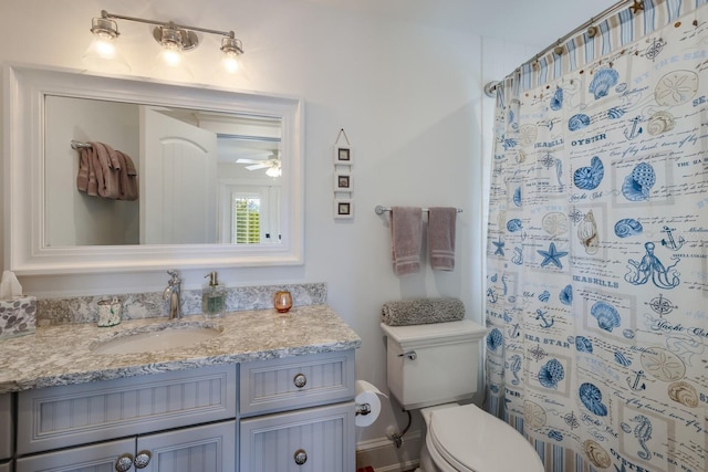 bathroom with ceiling fan, vanity, toilet, and a shower with curtain