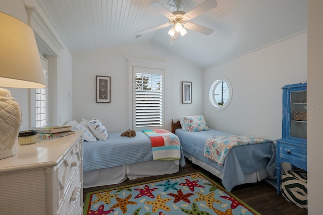 bedroom featuring a ceiling fan, multiple windows, vaulted ceiling, and wood finished floors