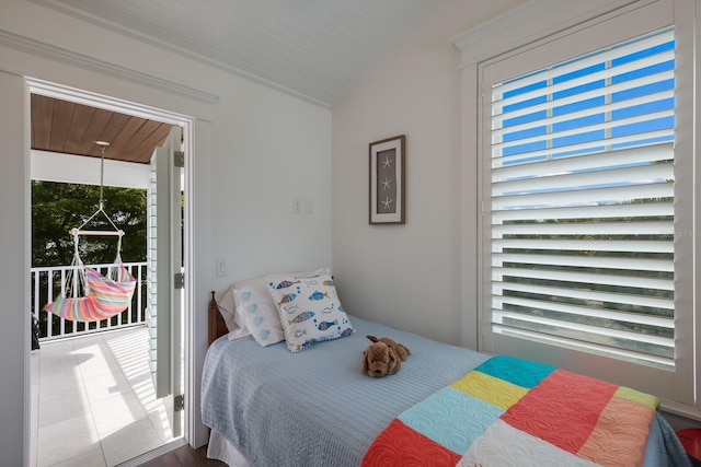 bedroom featuring lofted ceiling, wood ceiling, and multiple windows