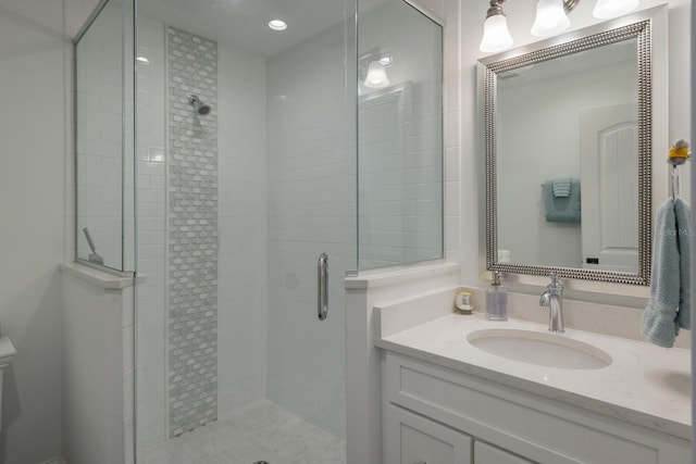 bathroom featuring toilet, a shower stall, recessed lighting, and vanity