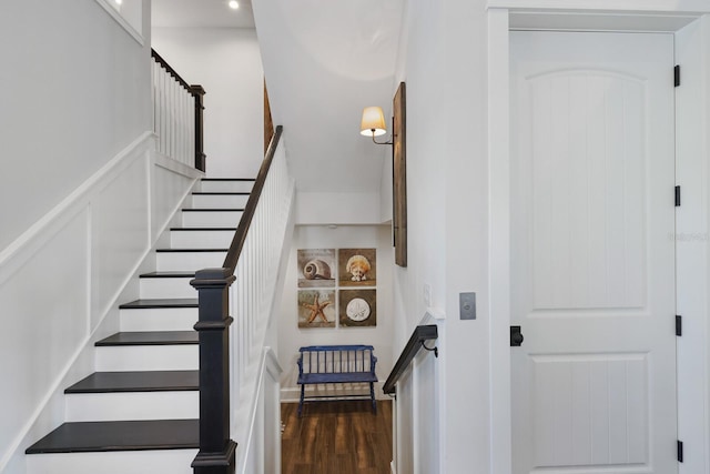 stairs featuring wood finished floors