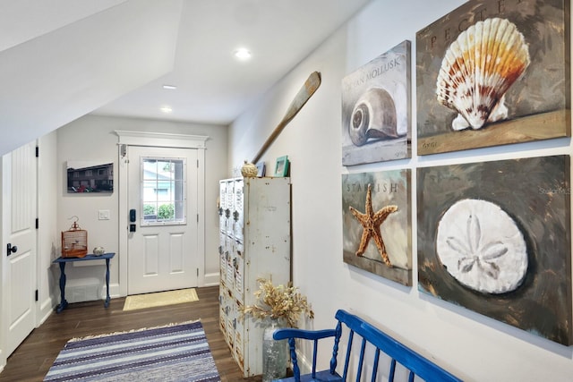 interior space with baseboards, wood finished floors, and recessed lighting