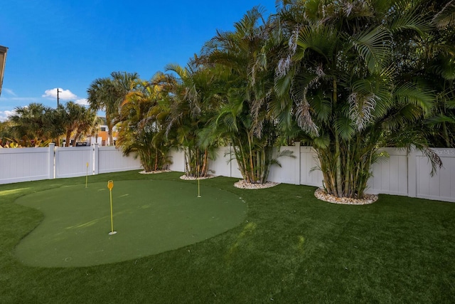 view of property's community with a fenced backyard and a yard