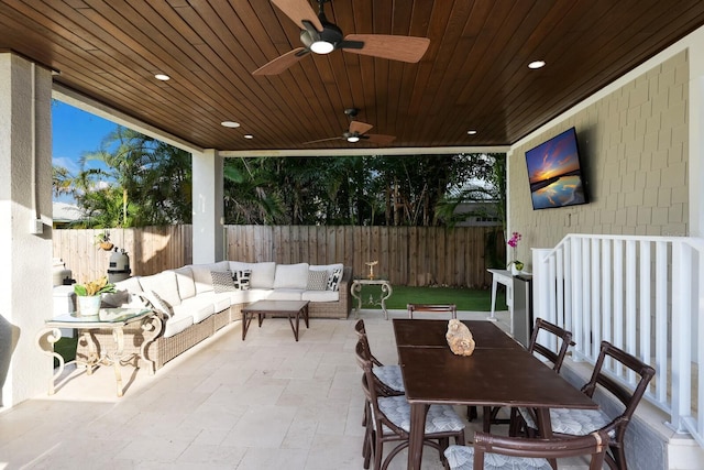 view of patio featuring outdoor dining area, ceiling fan, an outdoor living space, and a fenced backyard