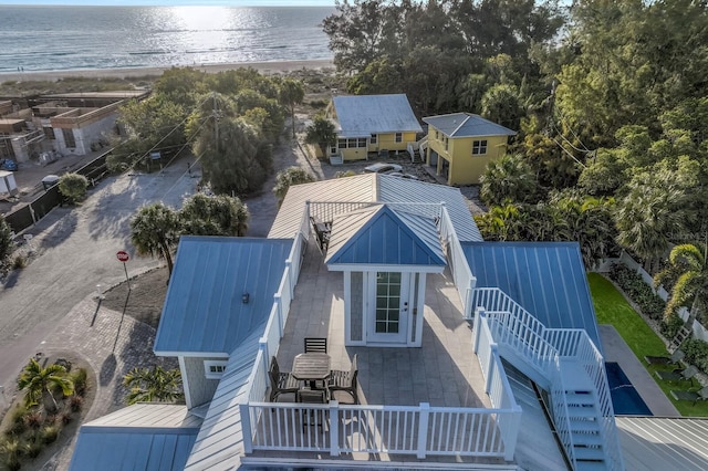 birds eye view of property featuring a water view and a beach view