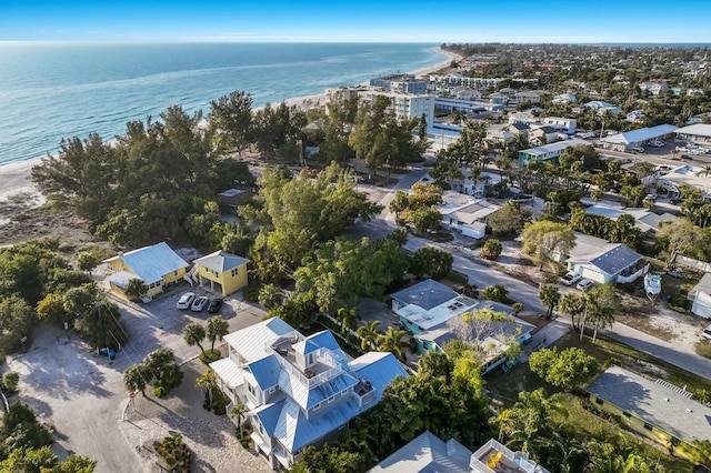 aerial view with a water view and a beach view