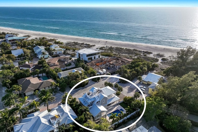 drone / aerial view featuring a water view, a residential view, and a view of the beach