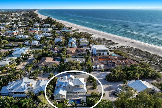 drone / aerial view with a water view, a residential view, and a beach view