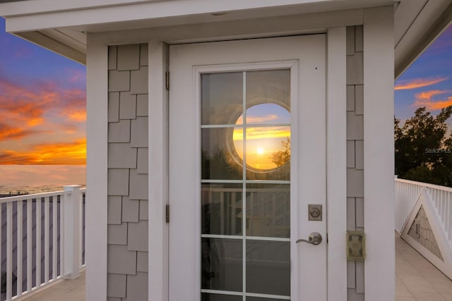 view of exterior entry at dusk