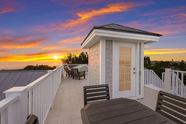 view of wooden balcony with outdoor dining space and a wooden deck