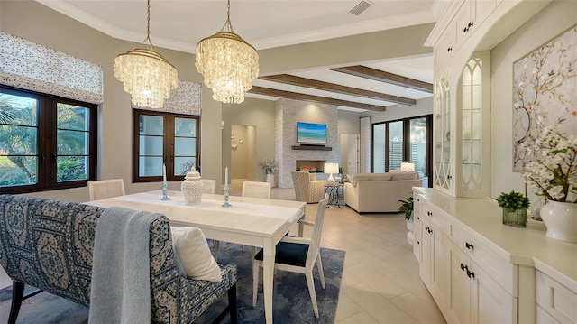 dining area featuring visible vents, plenty of natural light, a fireplace, and ornamental molding