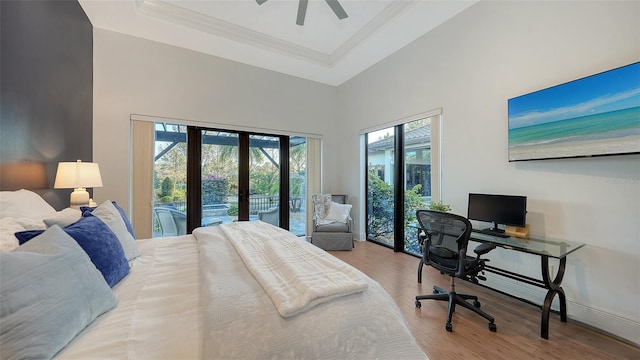 bedroom with baseboards, french doors, a high ceiling, wood finished floors, and access to outside