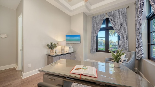 home office featuring crown molding, baseboards, and wood finished floors