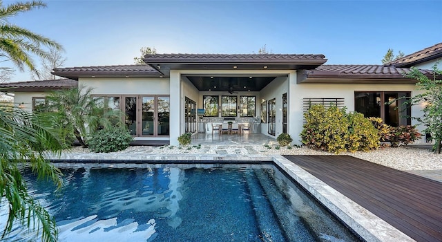 view of swimming pool featuring a patio and a ceiling fan