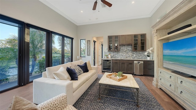 living room with wood finished floors, a high ceiling, beverage cooler, and crown molding