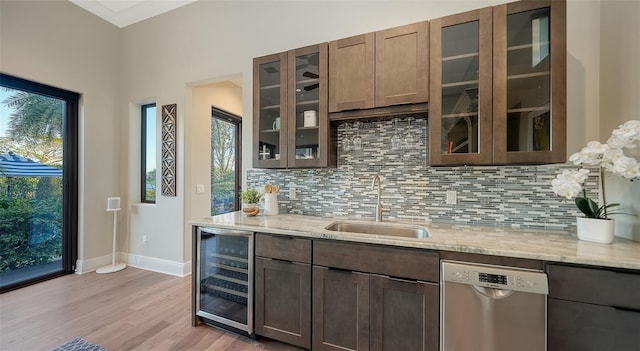 kitchen featuring a sink, wine cooler, light wood-style floors, stainless steel dishwasher, and tasteful backsplash