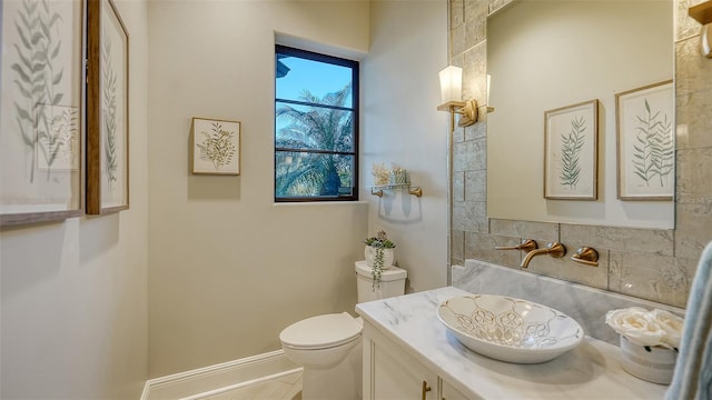 bathroom featuring toilet and vanity