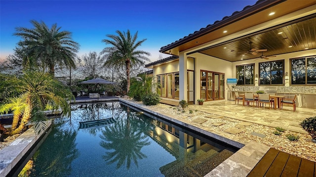 pool featuring a ceiling fan and a patio area