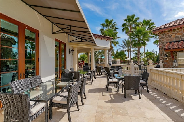 view of patio featuring outdoor dining space, french doors, and fence