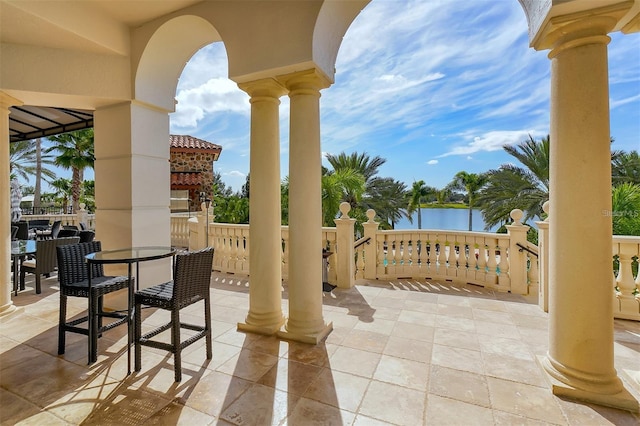 view of patio with outdoor dining area and a water view