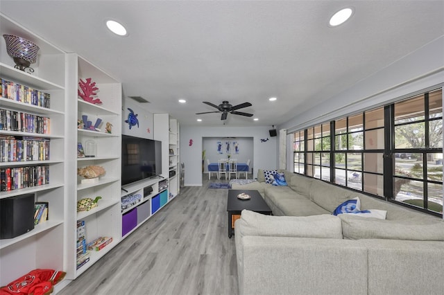 living area with recessed lighting, ceiling fan, and light wood-style flooring