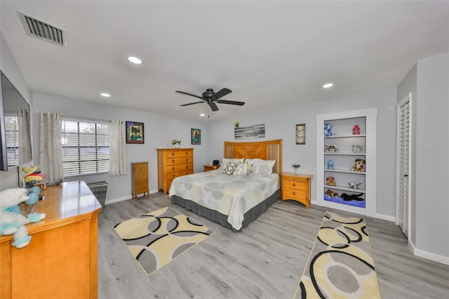 bedroom with light wood-style floors, recessed lighting, visible vents, and baseboards