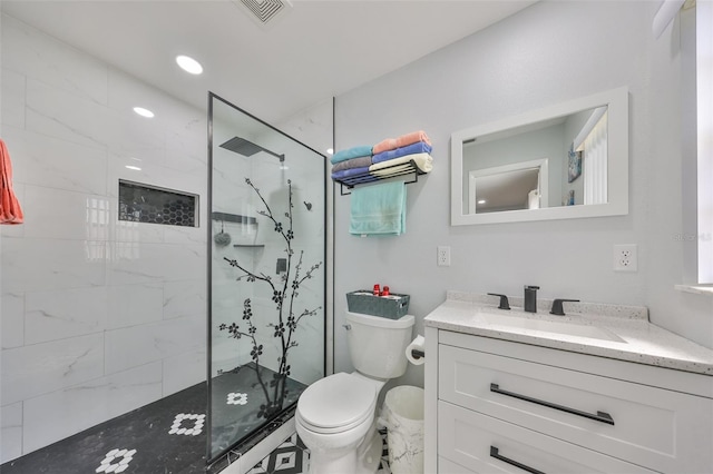 full bath with a marble finish shower, visible vents, toilet, vanity, and recessed lighting