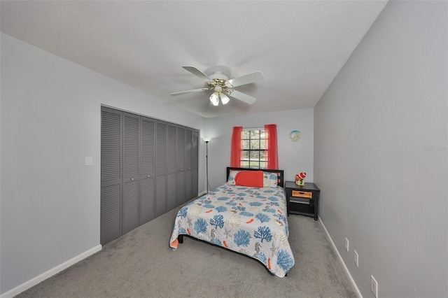 bedroom with a closet, carpet flooring, and baseboards