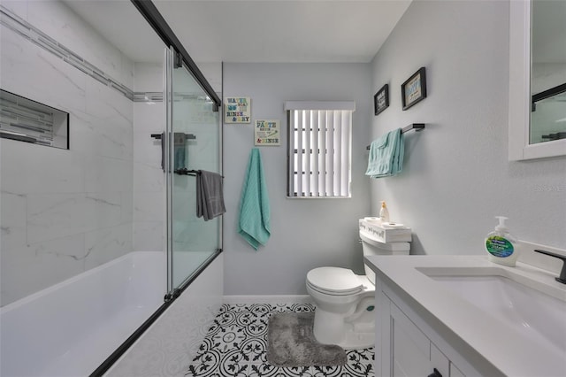 full bathroom with enclosed tub / shower combo, toilet, vanity, baseboards, and tile patterned floors