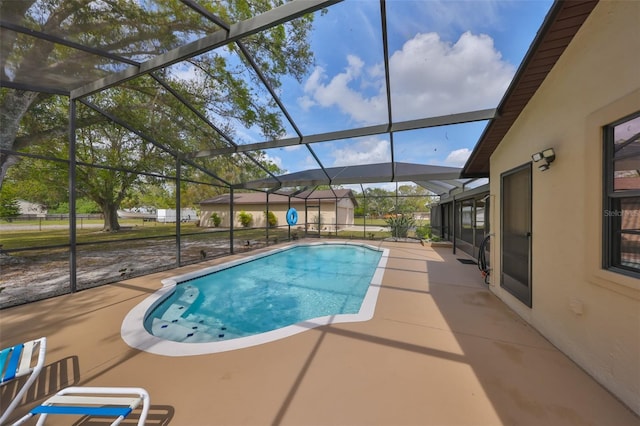 outdoor pool with a lanai and a patio