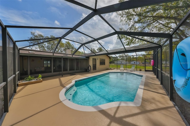 outdoor pool featuring a lanai and a patio