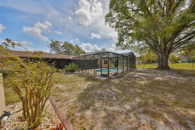 view of yard featuring a lanai and an outdoor pool