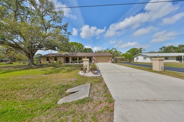 view of front of home featuring driveway, an attached garage, and a front yard