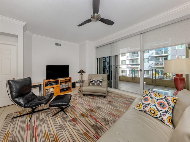 living area featuring a ceiling fan, tile patterned flooring, visible vents, and crown molding