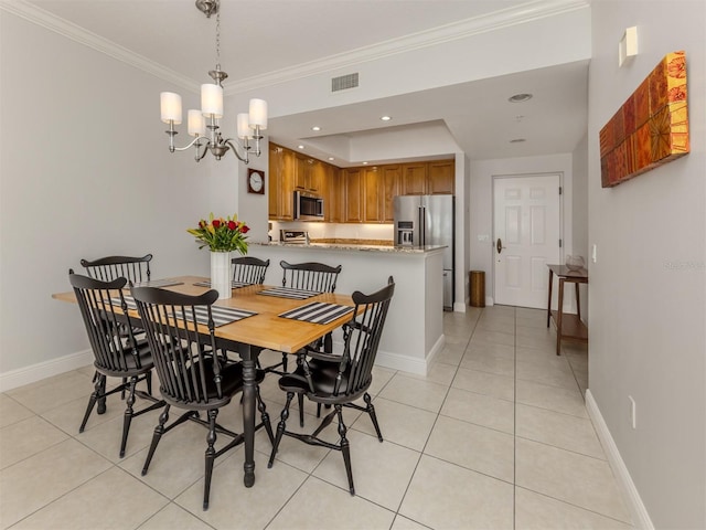 dining space featuring baseboards, light tile patterned flooring, visible vents, and crown molding