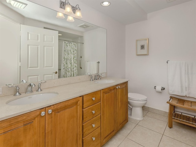 bathroom with visible vents, a sink, toilet, and tile patterned floors