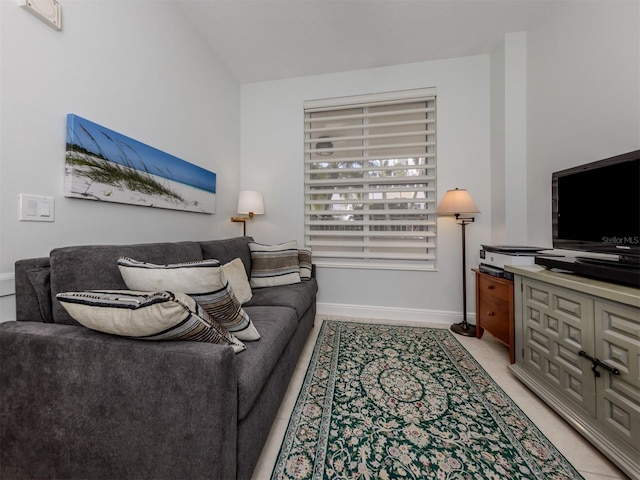 living room with light tile patterned flooring and baseboards