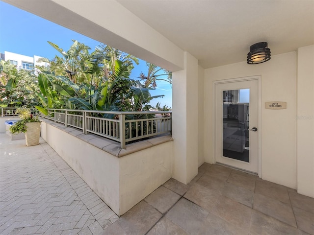 doorway to property featuring a balcony and stucco siding