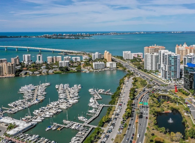 birds eye view of property featuring a water view and a city view