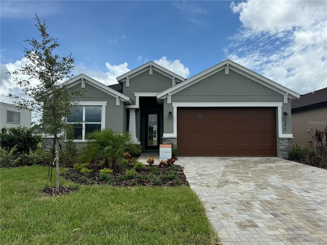 286 Hillshire Pl, Spring Hill, FL 34609 - view of front of property with stucco siding, a garage, stone siding, driveway, and a front yard