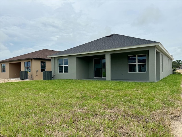 286 Hillshire Pl, Spring Hill, FL 34609 - back of house with stucco siding, a yard, and a shingled roof