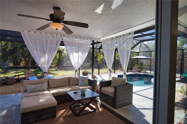 view of patio / terrace featuring an outdoor pool, a lanai, ceiling fan, and an outdoor hangout area