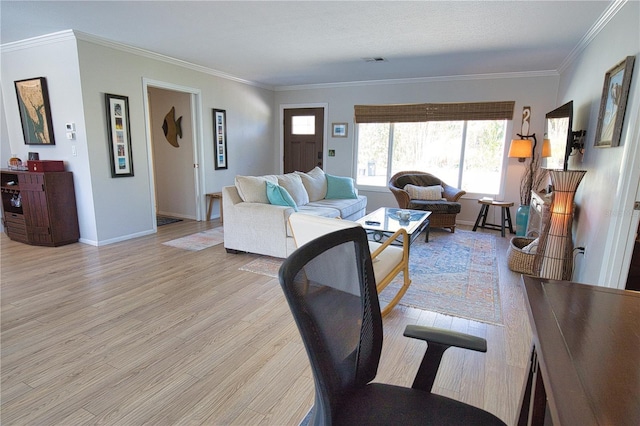 living area with light wood-type flooring, baseboards, visible vents, and ornamental molding