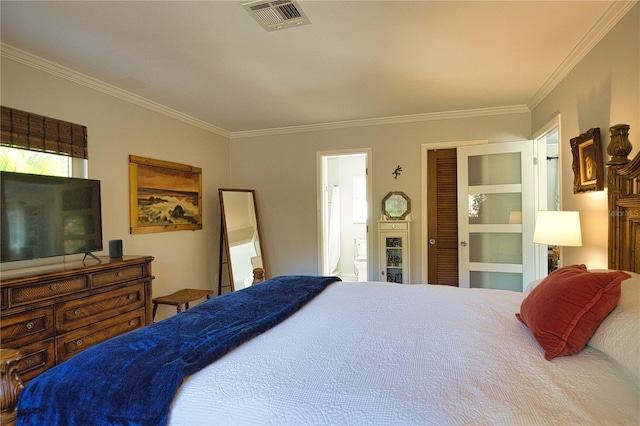 bedroom with connected bathroom, visible vents, and crown molding