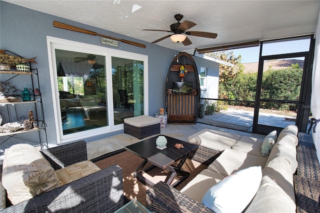 sunroom / solarium featuring ceiling fan